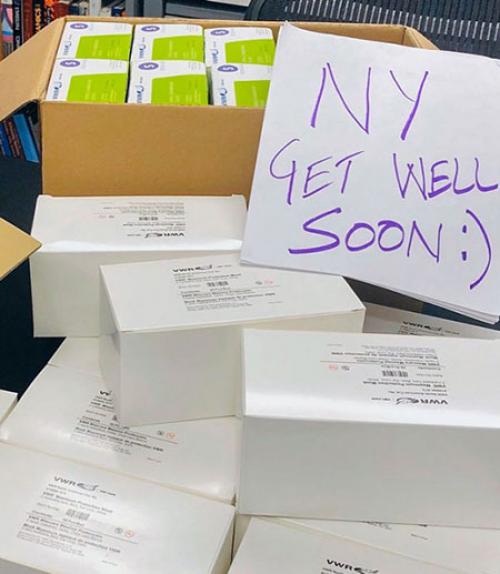 Boxes of donations with a sign saying &quot;NY Get Well Soon&quot;