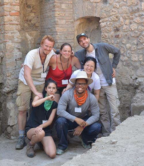 Six people in an ancient stone structure