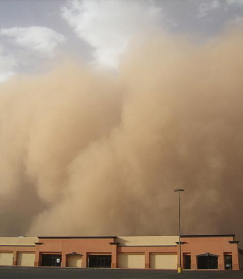 A dust storm engulfs a building