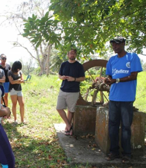  Students working with a local community member in Jamaica