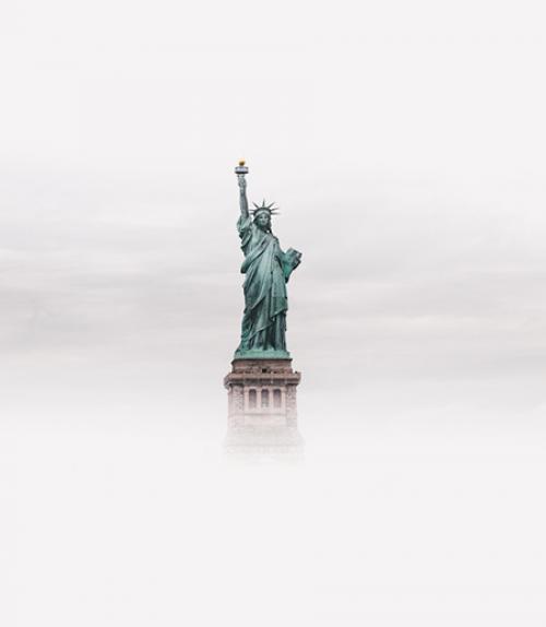  Statue of Liberty seen from a distance, surrounded by fog