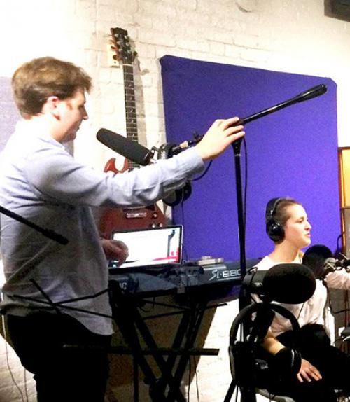  Two people surrounded by recording equipment