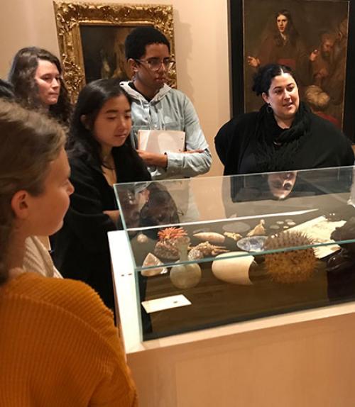 Students at Johnson Museum standing around a display of artifacts