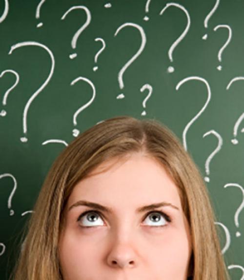Woman&#039;s face surrounded by question marks