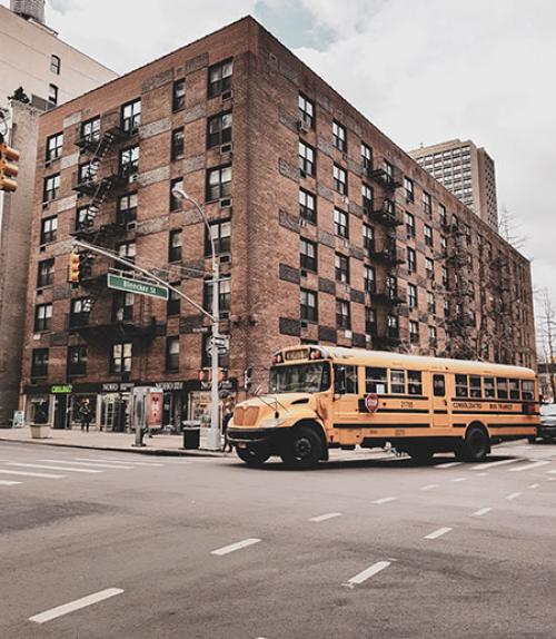  Big brick building in New York City with school bus in front of it