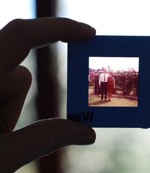 Fingers holding a photo of an elderly couple