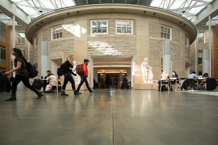 Students walking through the Klarman Hall atrium