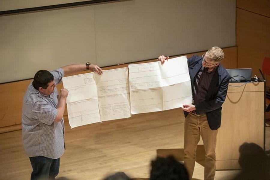Fillmmaker Jeffrey Palmer, left, and Austin Bunn, associate professor of performing and media arts, show off Palmer’s early plans for “Words from a Bear.”