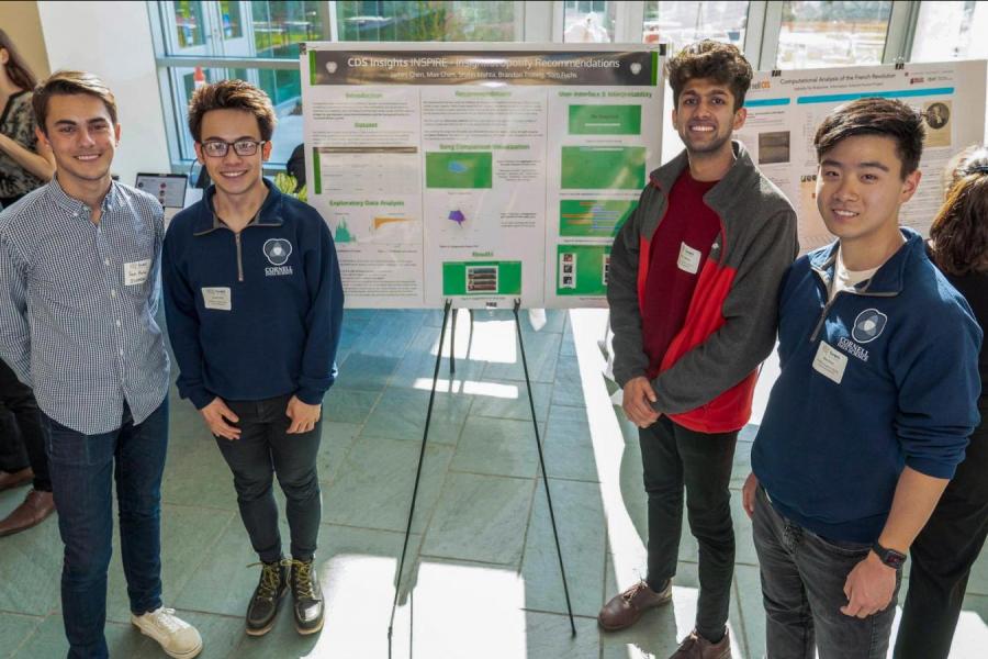 guys standing near research poster