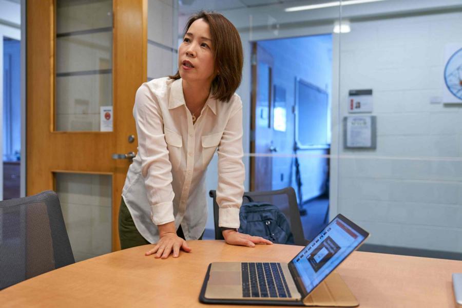 Eun-Ah Kim leaning over computer