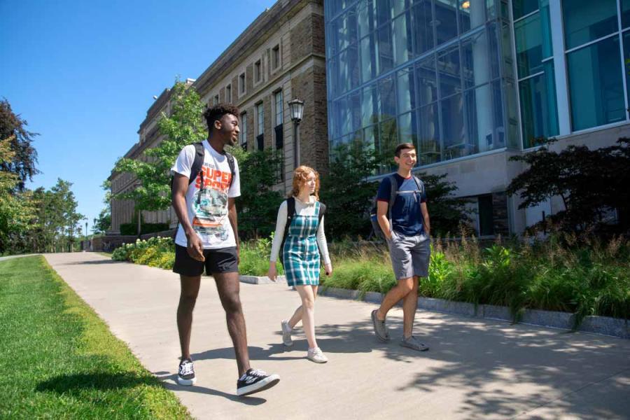 Students in the Pre-Collegiate Summer Scholars Program walking past the Physical Sciences Building