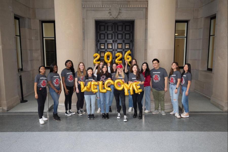 Student ambassadors holding 2026 balloons