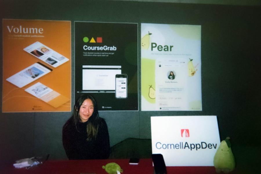 woman at table with app development signs