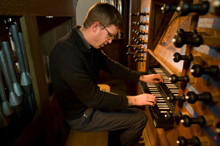 PERSON playing an organ