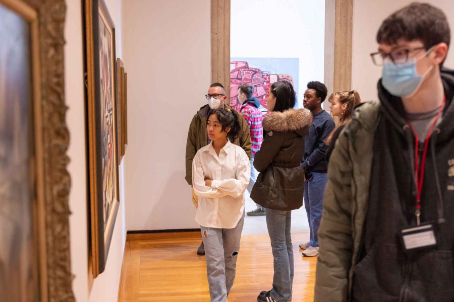 students looking at museum paintings