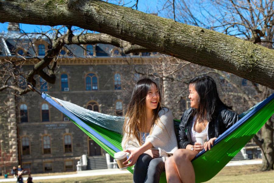 Students talking in a hammock on the Arts Quad