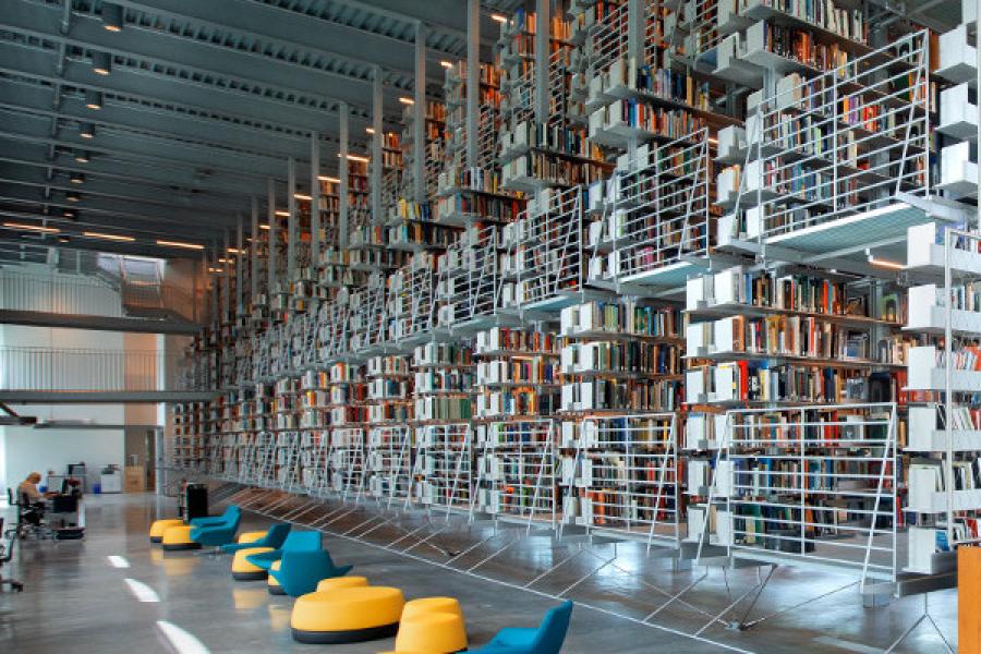 The Fine Arts Library has colorful seating and floors of metal book stacks
