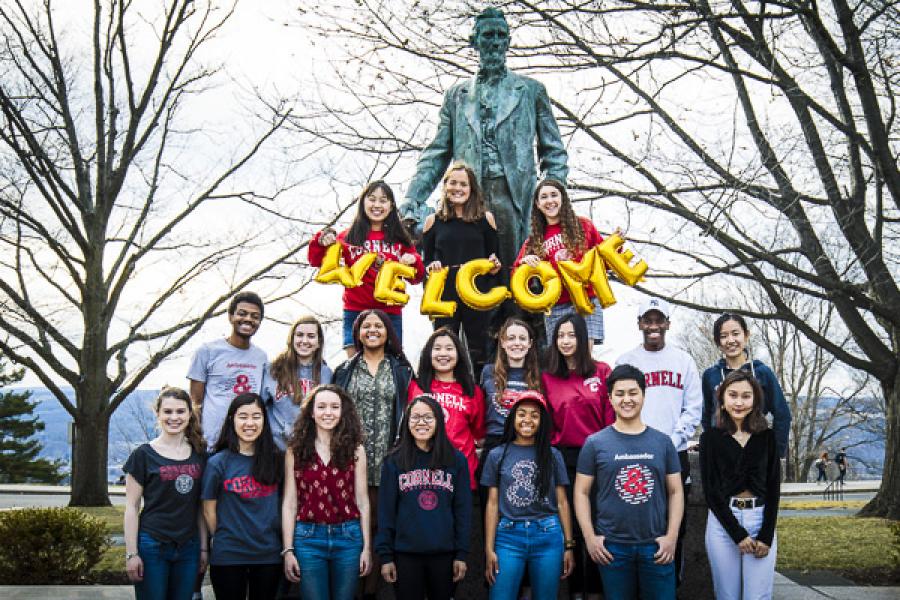 Arts &amp; Sciences student ambassadors gathered around the Ezra Cornell statue to welcome new students