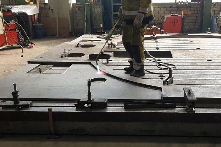Person welding a large platform