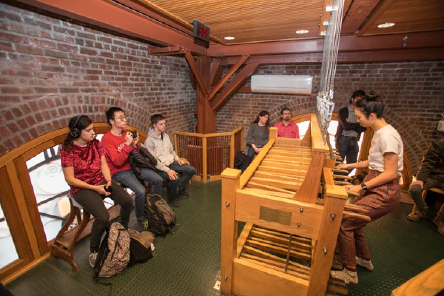 Billie Sun '19 plays the chimes while compositions watch