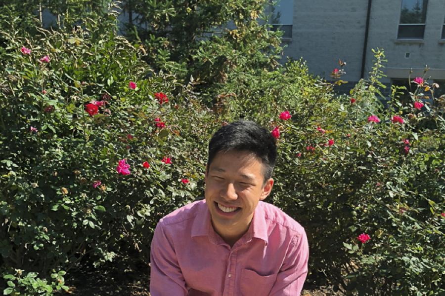 David Zhang in front of flowers
