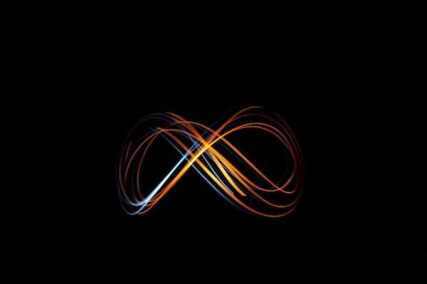 Multi-colored ribbons of light form the infinity symbol