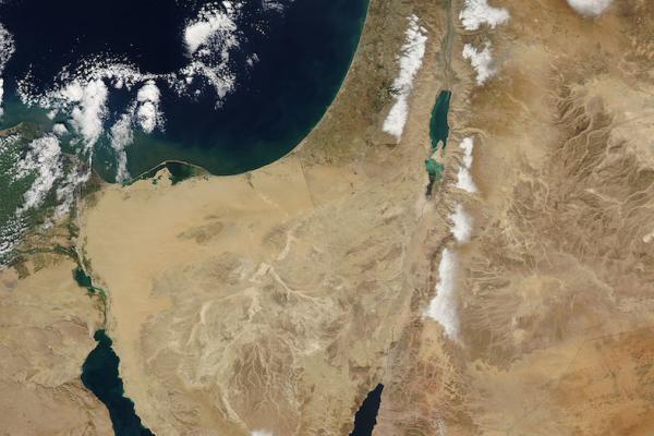 Satellite of the middle east region, seen from space: brown land, dark blue sea, highlights of snow, unusual for the region