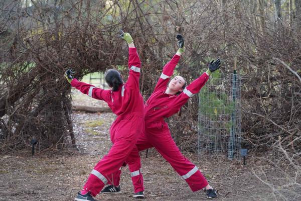 people dancing in red jumpsuits outside
