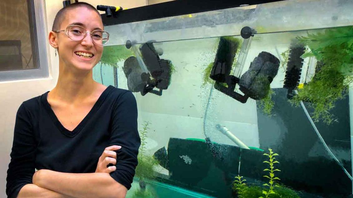 woman in front of fish tank