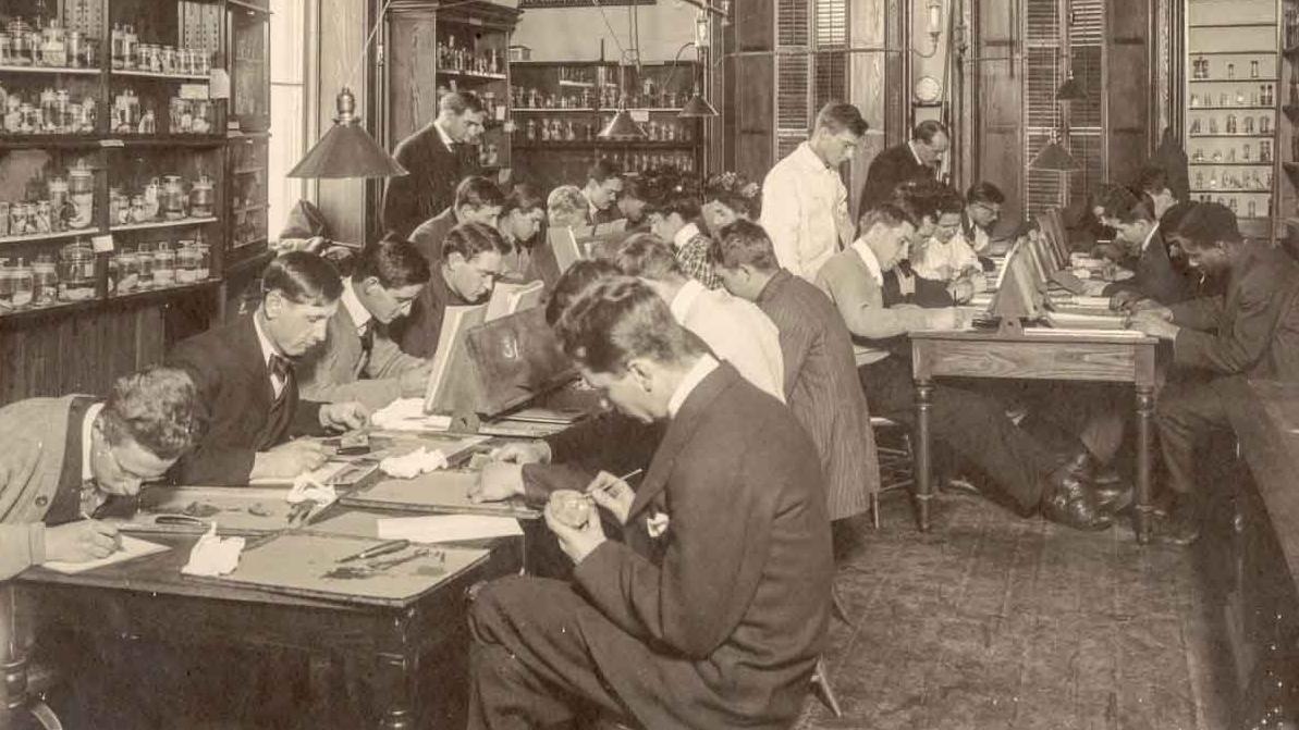 old photo of people working in a lab
