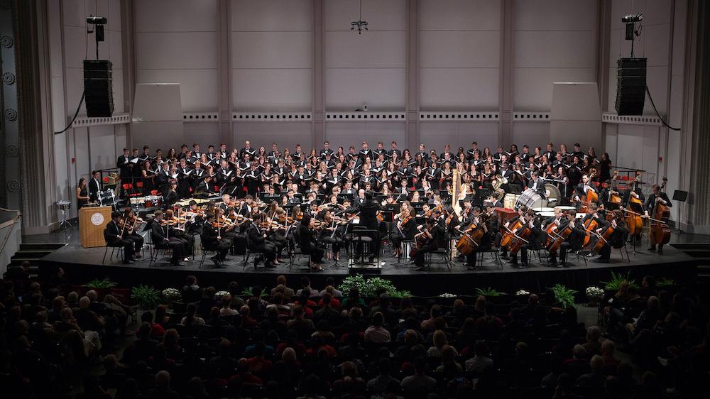 an orchestra and a chorus on a stage