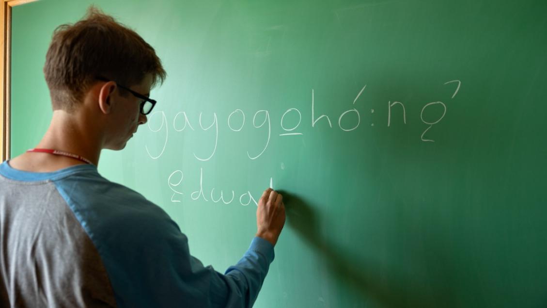 person writing on chalkboard