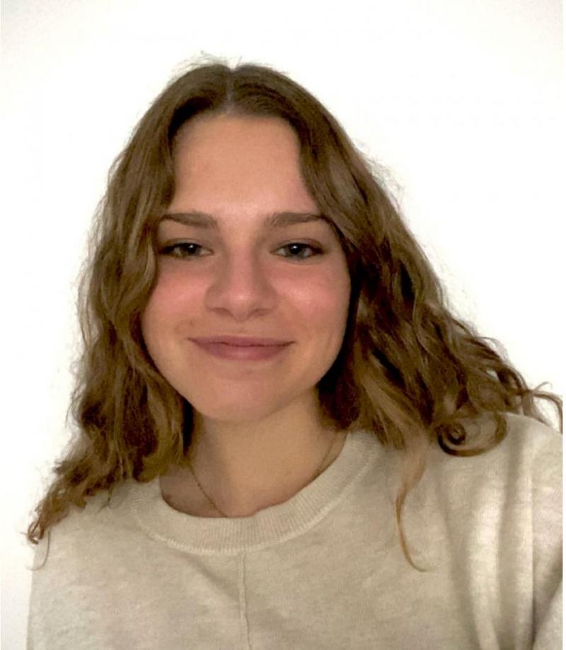 Marisabel Cabrera ’21 in a white sweater, self portrait.