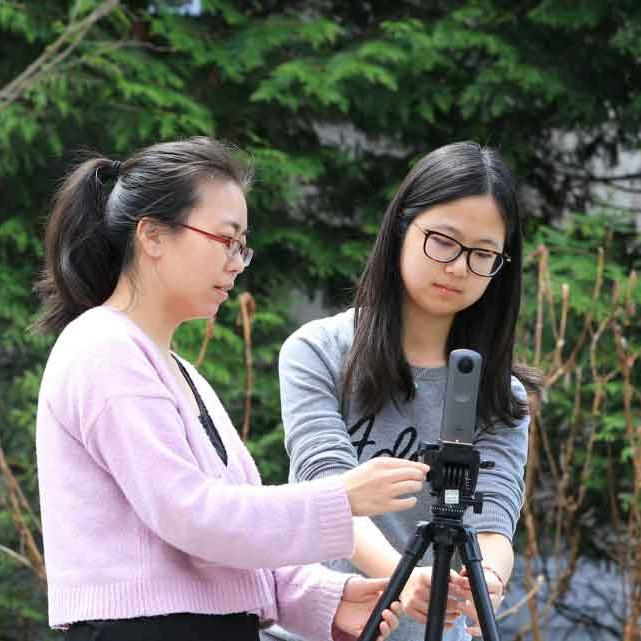 two students with video camera