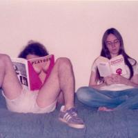 two people reading magazines