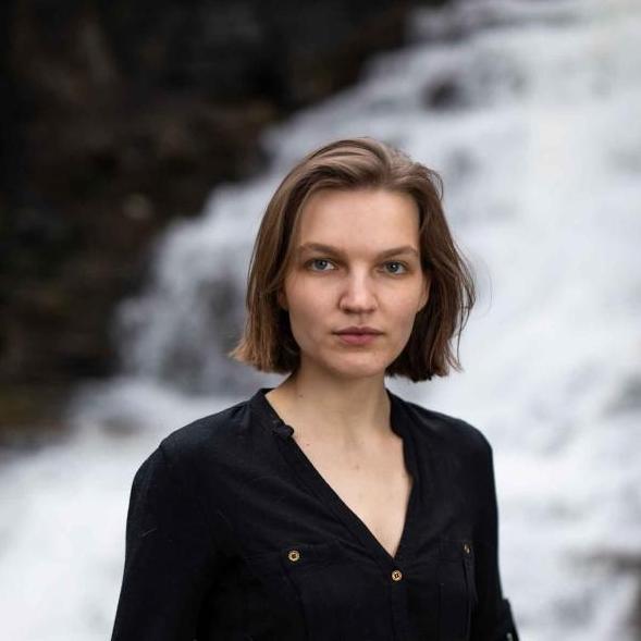 woman in front of waterfall