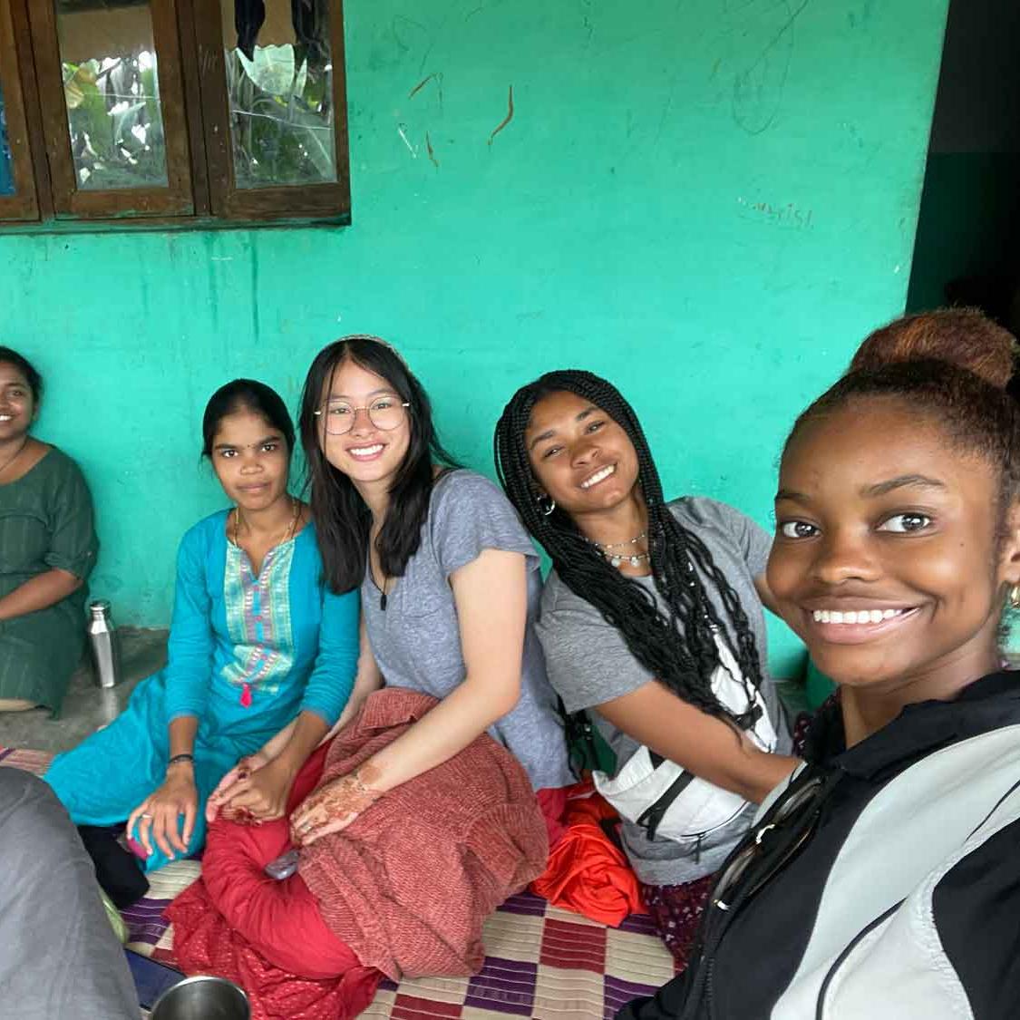 		people smiling and sitting on porch
	