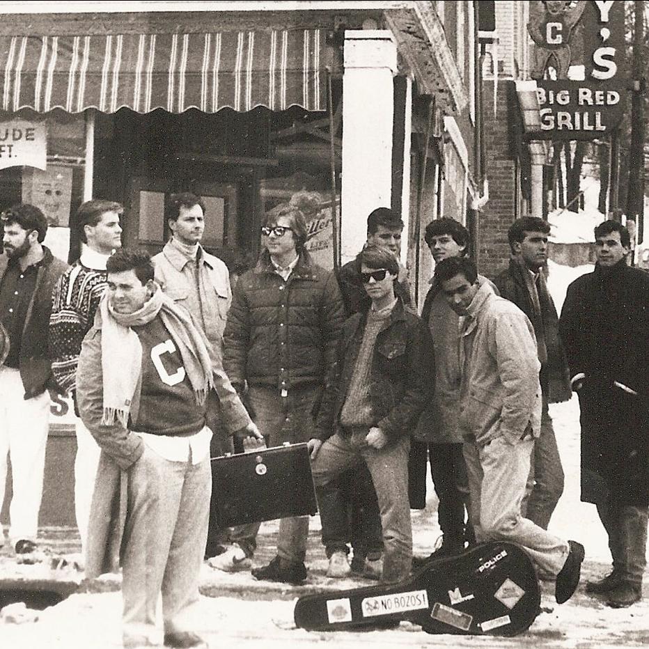 group of people standing on a street corner