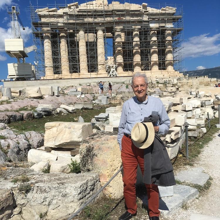 		Person standing on a path in front of columned ruins of the Parthenon 
	