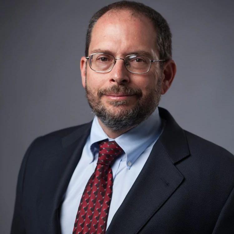 		Jonathan Lunine, with glasses, beard and mustache, and suit and tie
	