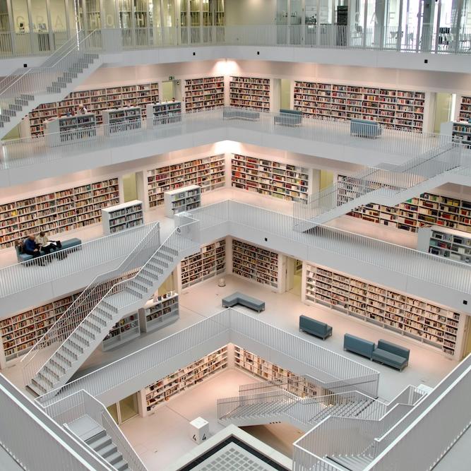 Very large, multi-tiered room lined with shelves of books