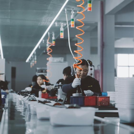 Line of people working in a factory