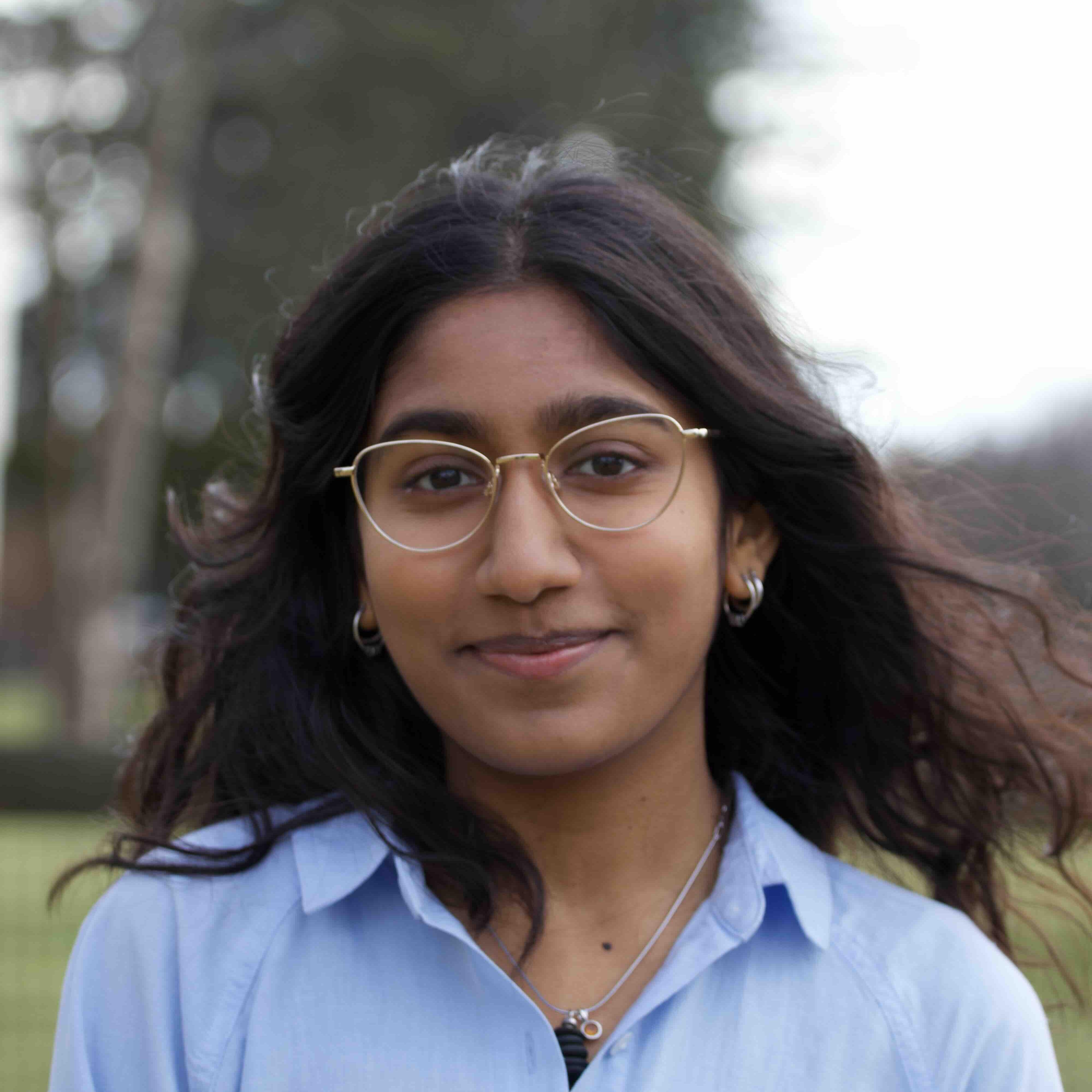 		Girl with blue Shirt and glasses 
	