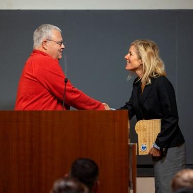 		Person accepts an award at a podium
	