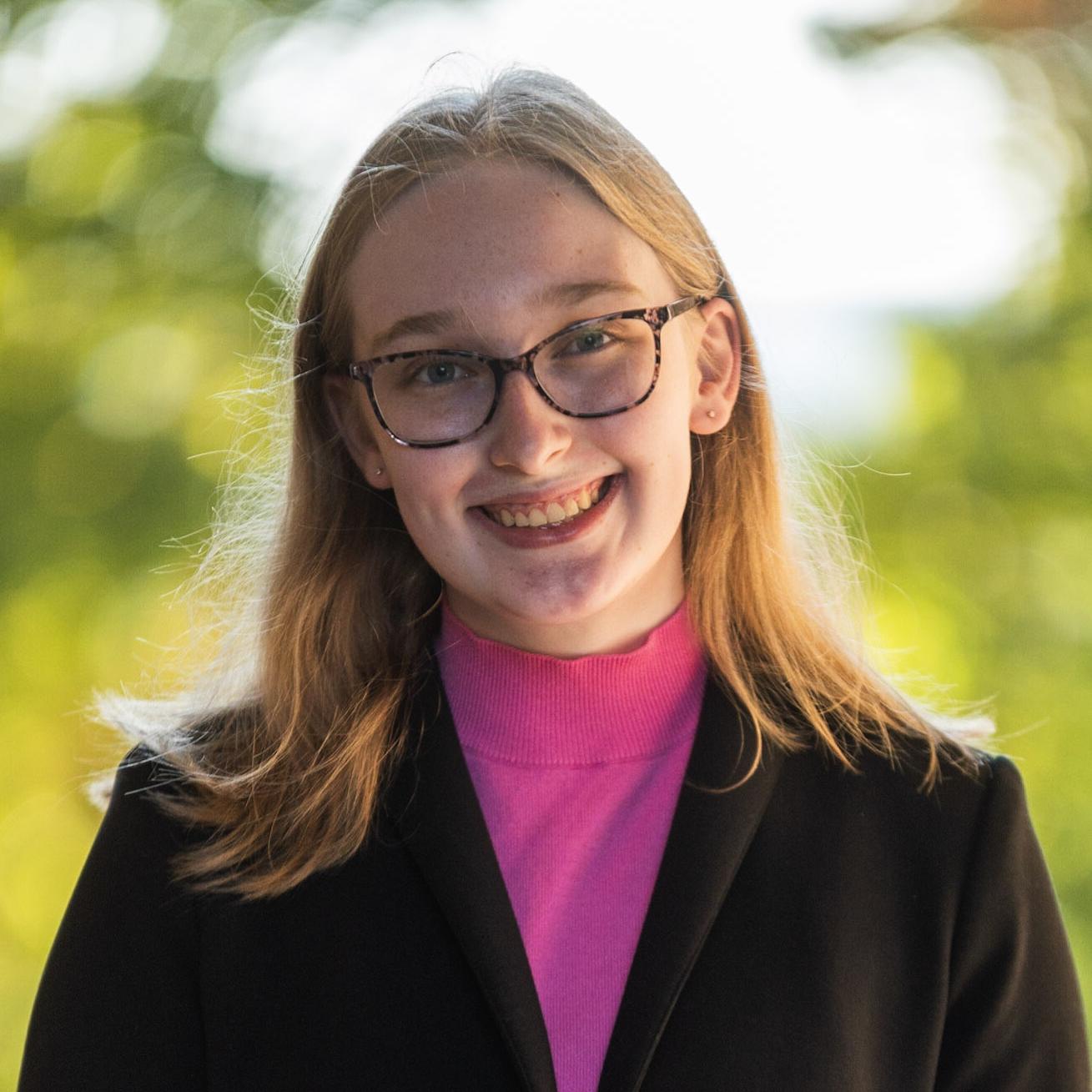 woman smiling while standing outside