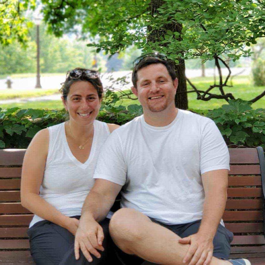 		two people on a park bench
	