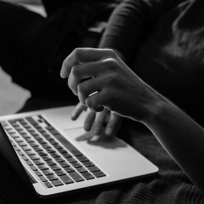 		hands typing on a computer
	