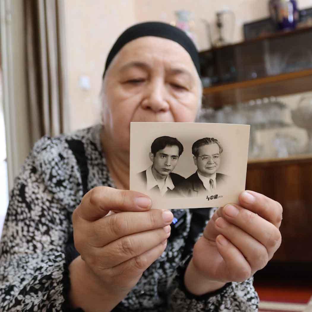 		woman holding a photo
	