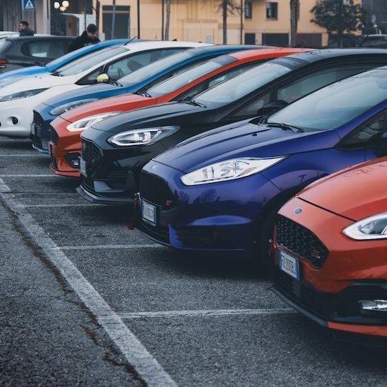 		Row of cars for sale in a parking lot
	