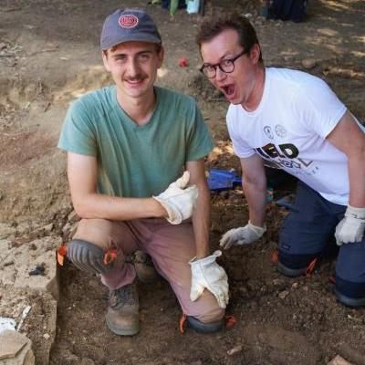 		Two people kneel in the dirt
	